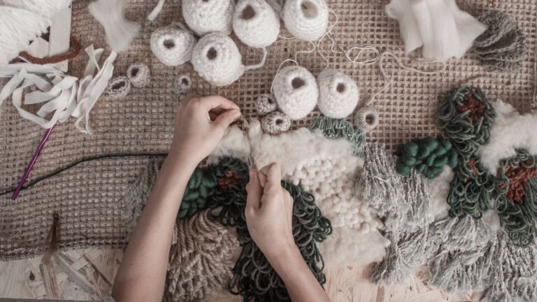 A woman doing embroidery on a cloth with the techniques used in textile art