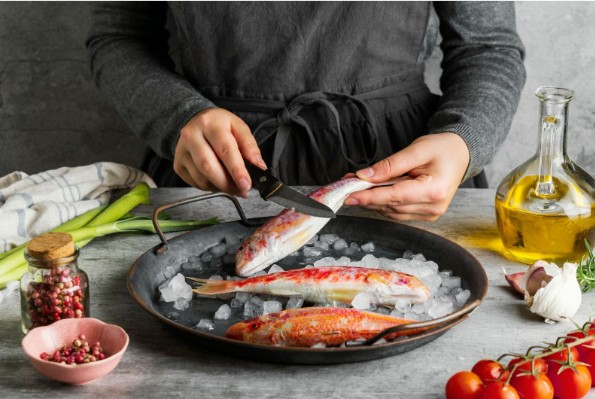 chef hand cooking fish home kitchen